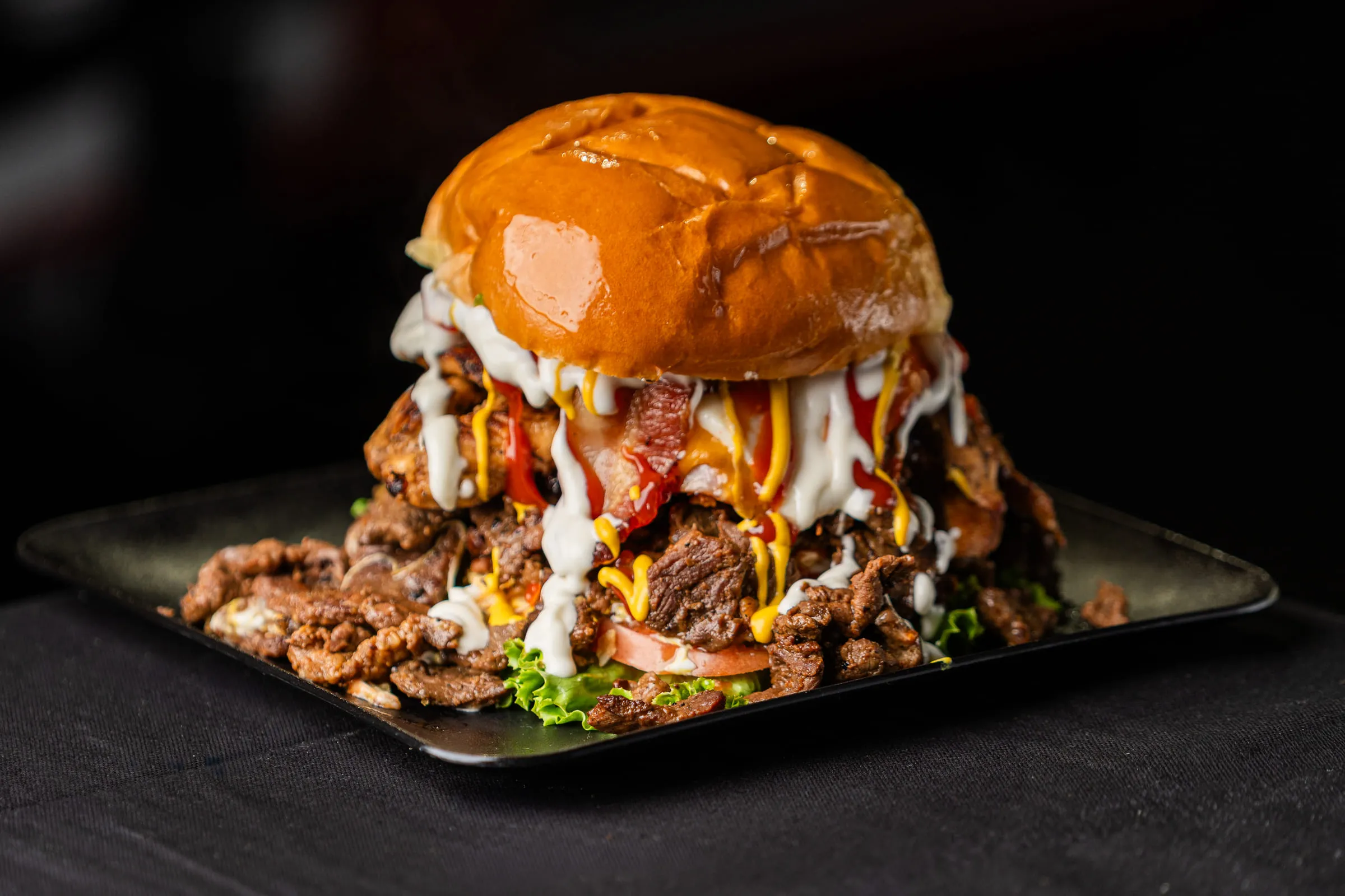 Loaded burger on steak platter — Food photography by JP Media Groups