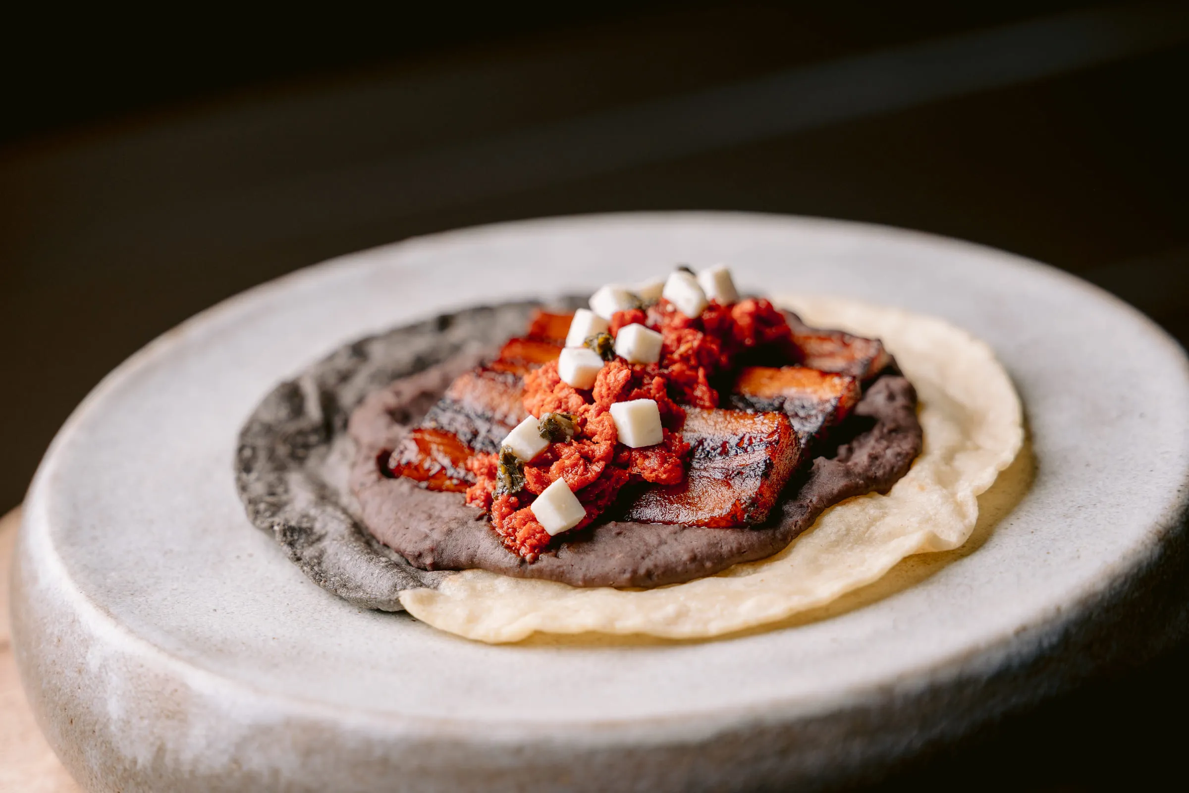 Black bean tostada with pork — Food photography by JP Media Groups