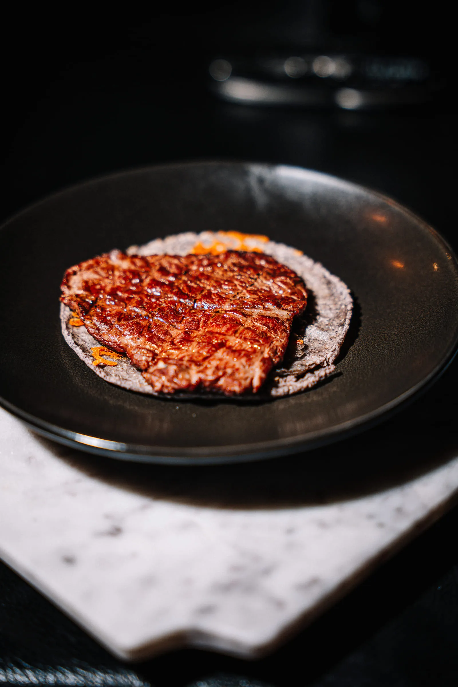 Glazed meat on blue corn tortilla — Food photography by JP Media Groups